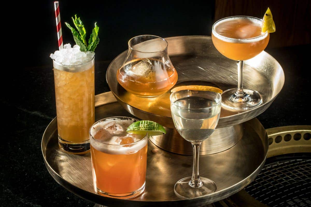 Five specialty cocktails on a tray 
