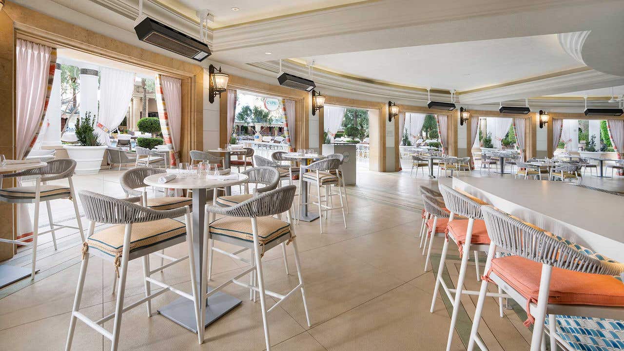 A patio dining area with high-top chairs and tables.