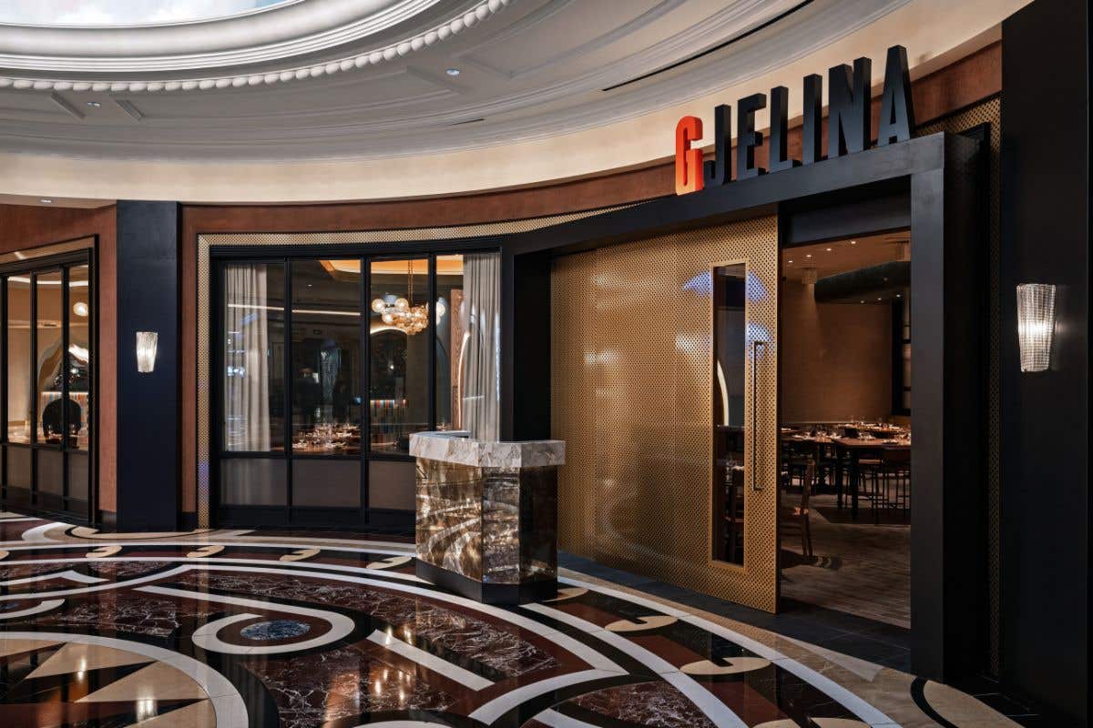 Front of the Gjelina restaurant with large windows and a gold door. 